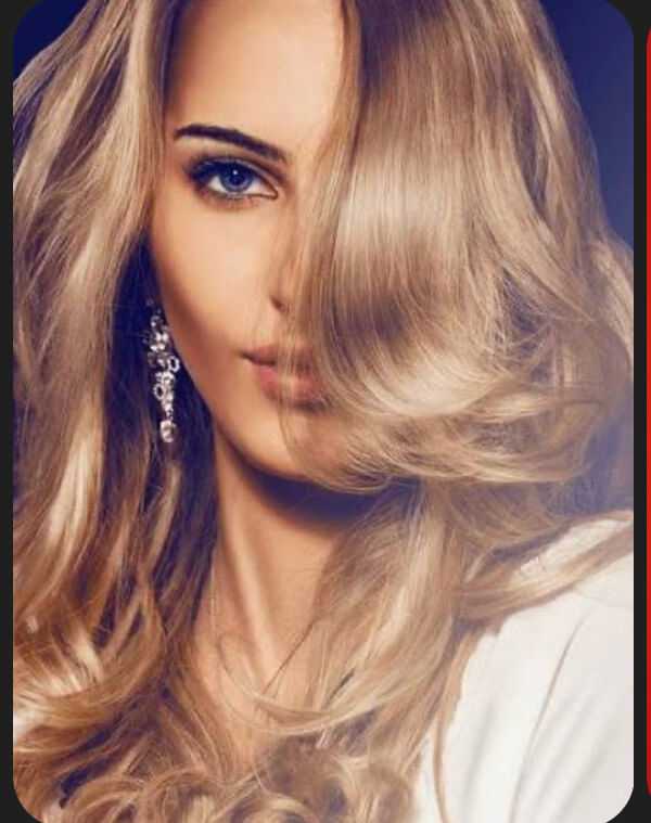 Woman with long, wavy blonde hair and an elegant earring, partially obscured face.